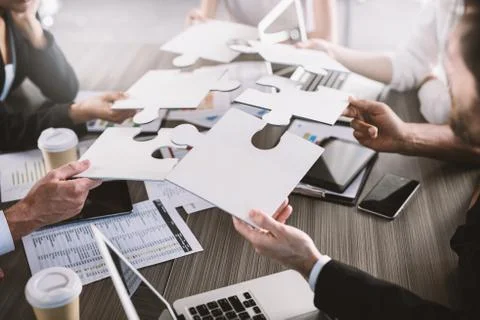 Teamwork of partners. Concept of integration and startup with puzzle pieces Stock Photos