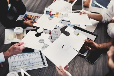 Teamwork of partners. Concept of integration and startup with puzzle pieces 写真素材