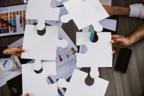 Teamwork of partners. Concept of integration and startup with puzzle pieces Stock Photos