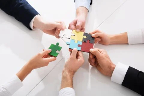 Teamwork of partners. Concept of integration and startup with puzzle pieces Stock Photos