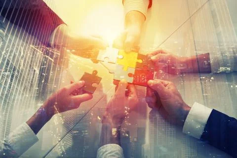 Teamwork of partners. Concept of integration and startup with puzzle pieces Stock Photos