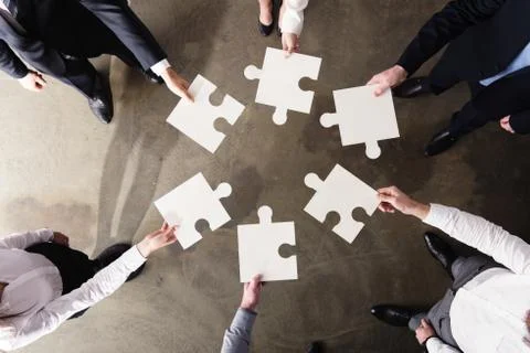 Teamwork of partners. Concept of integration and startup with puzzle pieces Stock Photos