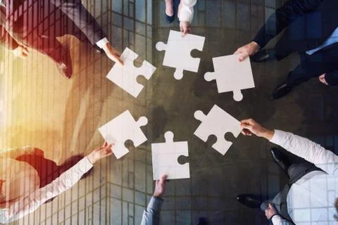 Teamwork of partners. Concept of integration and startup with puzzle pieces 写真素材