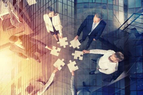 Teamwork of partners. Concept of integration and startup with puzzle pieces Stock Photos