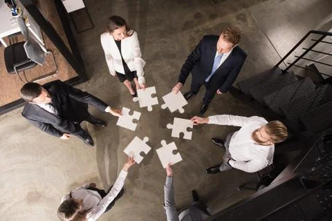 Teamwork of partners. Concept of integration and startup with puzzle pieces Stock Photos