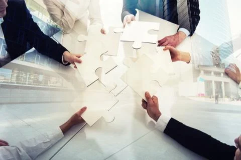 Teamwork of partners. Concept of integration and startup with puzzle pieces Stock Photos