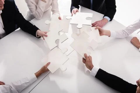 Teamwork of partners. Concept of integration and startup with puzzle pieces Stock Photos