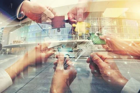 Teamwork of partners. Concept of integration and startup with puzzle pieces Stock Photos