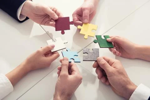 Teamwork of partners. Concept of integration and startup with puzzle pieces Stock Photos