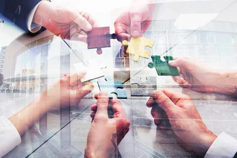 Teamwork of partners. Concept of integration and startup with puzzle pieces Stock Photos