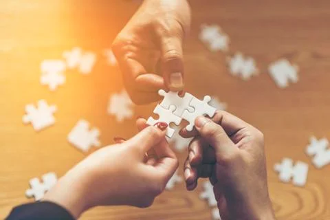Teamwork of partners. Concept of integration and startup with puzzle pieces.  Stock Photos