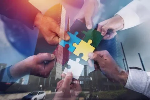 Teamwork of partners. Concept of integration and startup with puzzle pieces Stock Photos