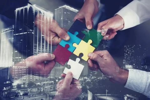 Teamwork of partners. Concept of integration and startup with puzzle pieces Stock Photos