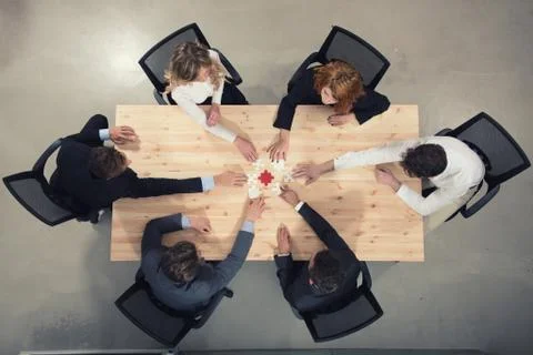 Teamwork of partners. Concept of integration and startup with puzzle pieces Stock Photos