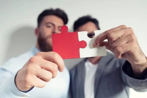 Teamwork of partners. Concept of integration and startup with puzzle pieces Stock Photos
