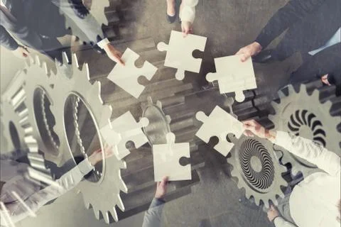 Teamwork of partners. Concept of integration and startup with puzzle pieces and 写真素材