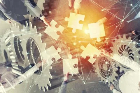 Teamwork of partners. Concept of integration and startup with puzzle pieces and Stock Photos