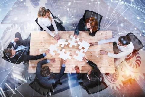 Teamwork of partners. Concept of integration and startup with puzzle pieces and Stock Photos