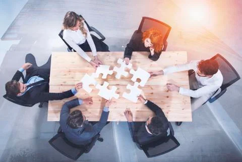 Teamwork of partners. Concept of integration and startup with puzzle pieces Stock Photos