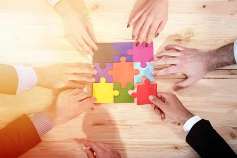 Teamwork of partners. Concept of integration and startup with puzzle pieces Stock Photos