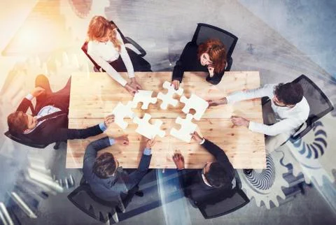 Teamwork of partners. Concept of integration and startup with puzzle pieces and Stock Photos