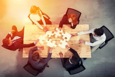 Teamwork of partners. Concept of integration and startup with puzzle pieces 写真素材