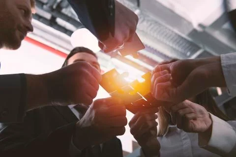 Teamwork of partners. Concept of integration and startup with puzzle pieces Stock Photos