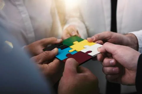Teamwork of partners. Concept of integration and startup with puzzle pieces Stock Photos