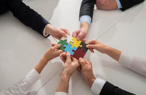 Teamwork of partners. Concept of integration and startup with puzzle pieces Stock Photos