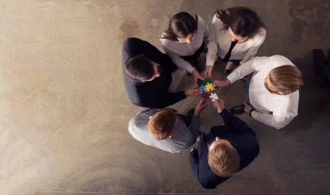 Teamwork of partners. Concept of integration and startup with puzzle pieces Stock Photos