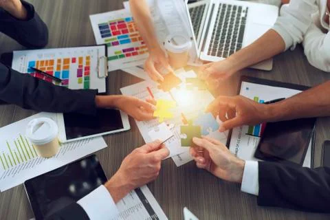 Teamwork of partners. Concept of integration and startup with puzzle pieces Stock Photos