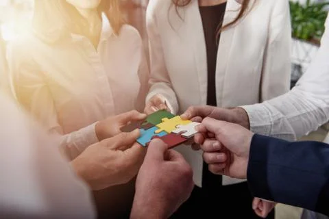 Teamwork of partners. Concept of integration and startup with puzzle pieces. Stock Photos