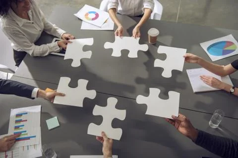 Teamwork of partners. Concept of integration and startup with puzzle pieces Stock Photos