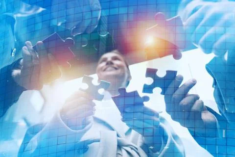 Teamwork of partners. Concept of integration and startup with puzzle pieces Stock Photos