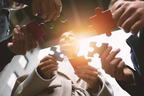 Teamwork of partners. Concept of integration and startup with puzzle pieces Stock Photos