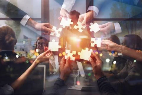 Teamwork of partners. Concept of integration and startup with puzzle pieces Stock Photos