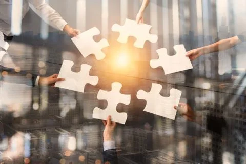 Teamwork of partners. Concept of integration and startup with puzzle pieces Stock Photos
