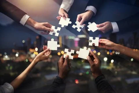 Teamwork of partners. Concept of integration and startup with puzzle pieces Stock Photos
