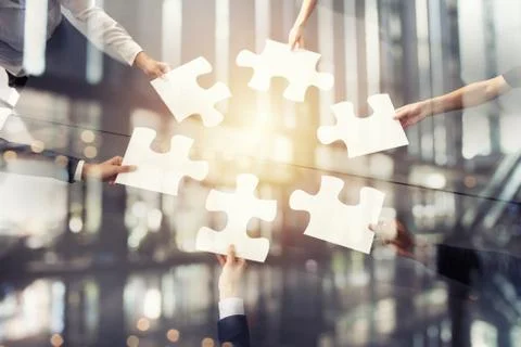 Teamwork of partners. Concept of integration and startup with puzzle pieces Stock Photos