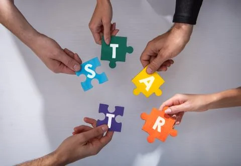 Teamwork of partners. Concept of integration and startup with puzzle pieces Stock Photos