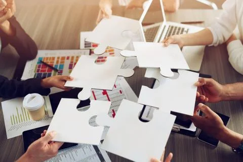 Teamwork of partners. Concept of integration and startup with puzzle pieces Stock Photos