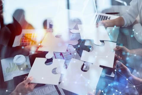 Teamwork of partners. Concept of integration and startup with puzzle pieces Stock Photos