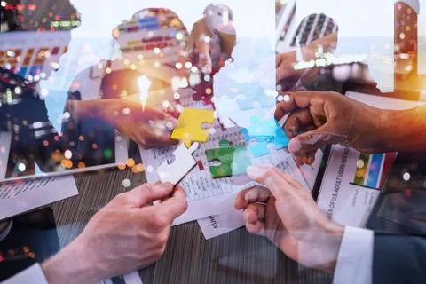 Teamwork of partners. Concept of integration and startup with puzzle pieces Stock Photos