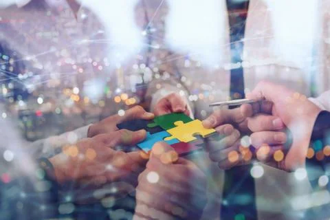 Teamwork of partners. Concept of integration and startup with puzzle pieces Stock Photos