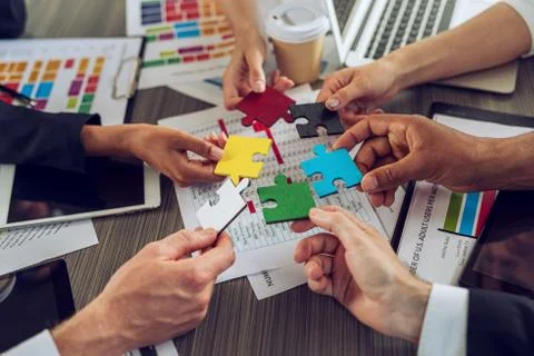 Teamwork of partners. Concept of integration and startup with puzzle pieces Stock Photos