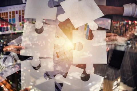 Teamwork of partners. Concept of integration and startup with puzzle pieces Stock Photos