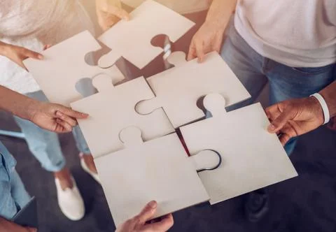 Teamwork of partners. Concept of integration and startup with puzzle pieces Stock Photos