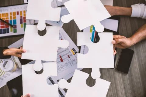 Teamwork of partners. Concept of integration and startup with puzzle pieces Stock Photos