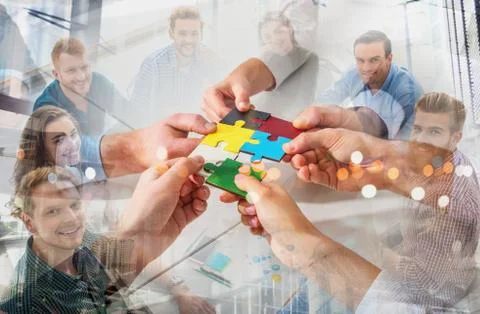 Teamwork of partners. Concept of integration and startup with puzzle pieces Stock Photos
