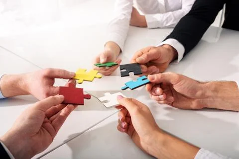 Teamwork of partners. Concept of integration and startup with puzzle pieces Stock Photos